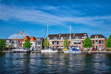 Image showing Boats and houses on Spaarne river. Haarlem, Netherlands