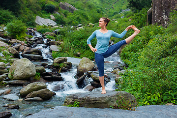 Image showing Woman doing Ashtanga Vinyasa Yoga asana outdoors at waterfall