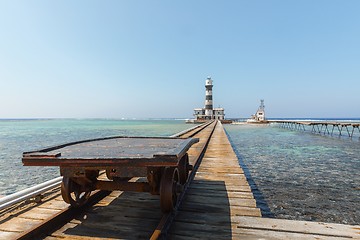 Image showing Railcart on pier with lighthouse