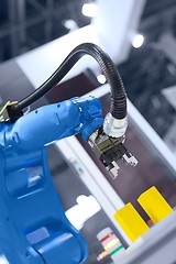 Image showing Automatic robot arm working in industrial environment