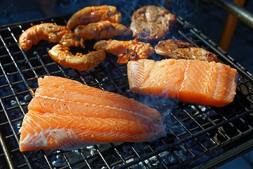 Image showing Salmon stake frying outside on the fire