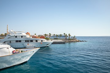 Image showing Luxury yacht docking near dock