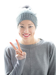 Image showing Close up portrait of cheerful caucasian woman, gesturing peace sign and smiles