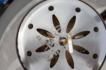 Image showing public ashtray with cigarettes