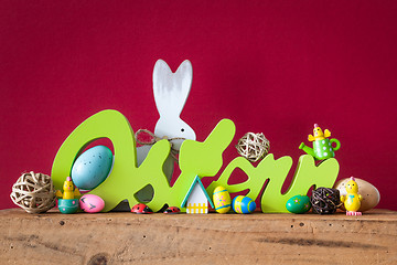 Image showing Word Easter in german language with easter bunny eggs and chicks