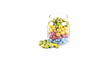 Image showing Colorful sweet candies in glass jar isolated on white.