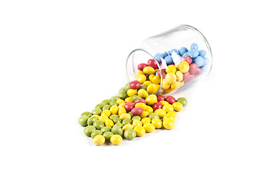 Image showing Colorful sweet candies in glass jar isolated on white.