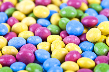 Image showing Pile of delicious ainbow colorful chocolate candies background.