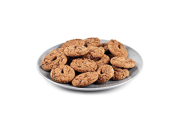 Image showing Fresh baked chocolate chip cookies heap on grey plate isolated o