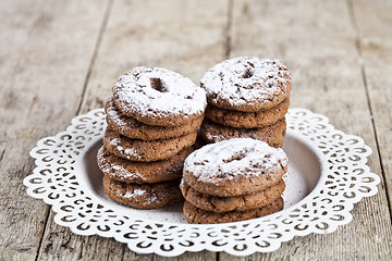 Image showing Fresh baked chocolate chip cookies with sugar powder heap on whi