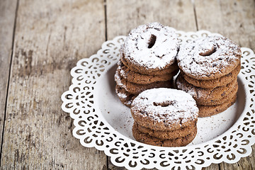 Image showing Fresh baked chocolate chip cookies with sugar powder heap on whi