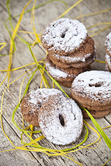 Image showing Fresh baked chocolate chip cookies with sugar powder stacks on w