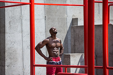 Image showing Athlete doing exercises at stadium