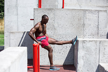 Image showing Athlete doing exercises at stadium