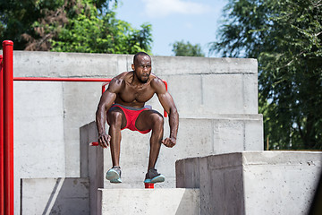 Image showing Athlete doing exercises at stadium