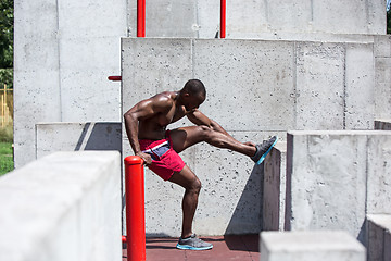 Image showing Athlete doing exercises at stadium