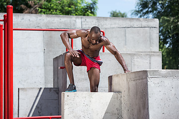 Image showing Athlete doing exercises at stadium