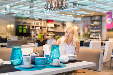 Image showing Beautiful young woman shopping in retail store.