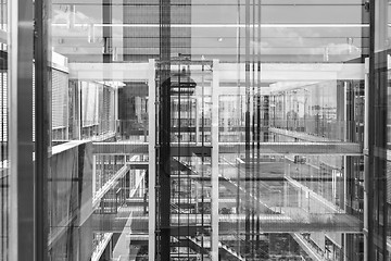 Image showing Abstract window reflections in morden office building. Black and white photo.