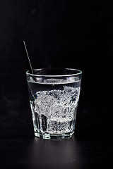 Image showing Glass of fresh cold carbonated water with ice cubes.