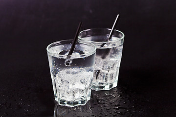 Image showing Two glasses of fresh cold carbonated water with ice cubes.