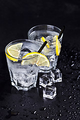 Image showing Glasses with fresh cold carbonated water with ice cubes and lemo