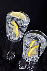 Image showing Glasses of fresh cold carbonated water with ice cubes and lemon 