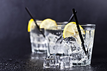 Image showing Three glasses with fresh cold carbonated water with lemon slices