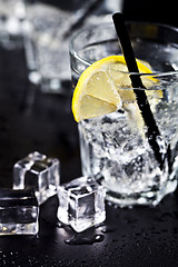 Image showing Glasses with fresh cold carbonated water with lemon slices and i