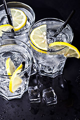 Image showing Three glasses with fresh cold carbonated water with lemon slices