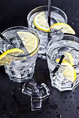 Image showing Three glasses with fresh cold carbonated water with lemon slices