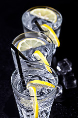 Image showing Three glasses with fresh cold carbonated water with lemon slices