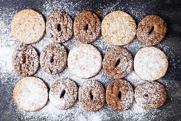 Image showing Chocolate chip and oat fresh cookies with sugar powder closeup o