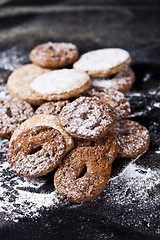 Image showing Chocolate chip and oat fresh cookies with sugar powder heap.