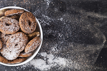 Image showing Fresh baked chocolate chip and oat fresh cookies with sugar powd