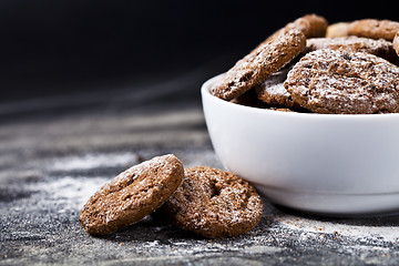 Image showing Fresh baked chocolate chip and oat fresh cookies with sugar powd