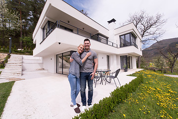 Image showing couple hugging in front of  new luxury home