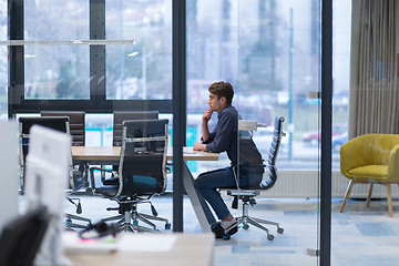 Image showing young businessman relaxing at the desk