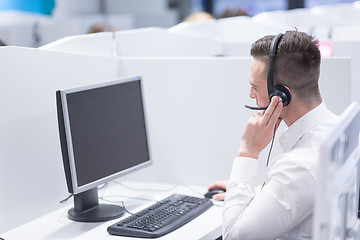 Image showing male call centre operator doing his job