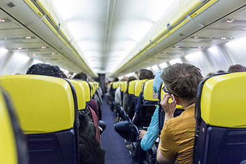 Image showing Interior of commercial airplane during flight.