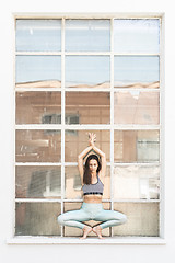 Image showing Fit sporty active girl in fashion sportswear doing yoga fitness exercise in front of gray wall, outdoor sports, urban style