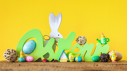Image showing Word Easter in german language with easter bunny eggs and chicks