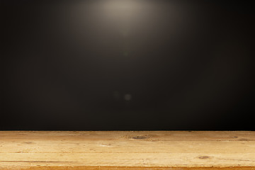 Image showing black background light wooden table