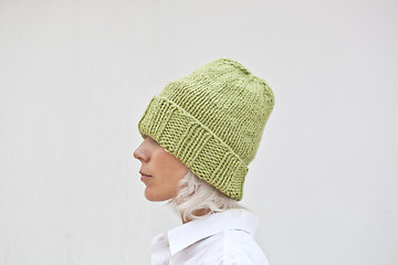 Image showing Pretty young woman in warm green knitted hat.