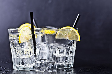 Image showing Three glasses with fresh cold carbonated water with lemon slices