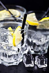 Image showing Three glasses with fresh cold carbonated water with lemon slices