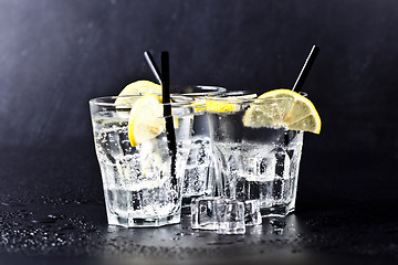 Image showing Three glasses of fresh cold carbonated water with ice cubes and 