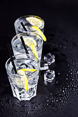 Image showing Three glasses with fresh cold carbonated water with lemon slices