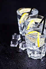 Image showing Three glasses with fresh cold carbonated water with lemon slices