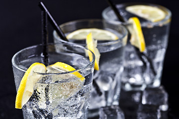 Image showing Three glasses with fresh cold carbonated water with lemon slices